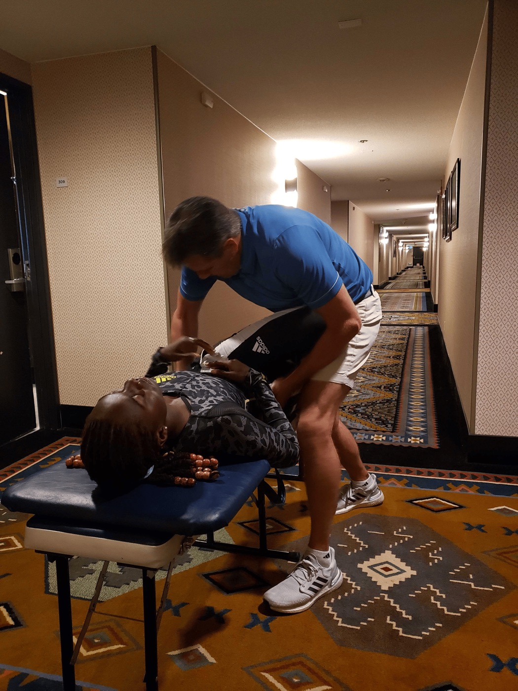 Dr. Obetz adjusting Lynna Irby before a race