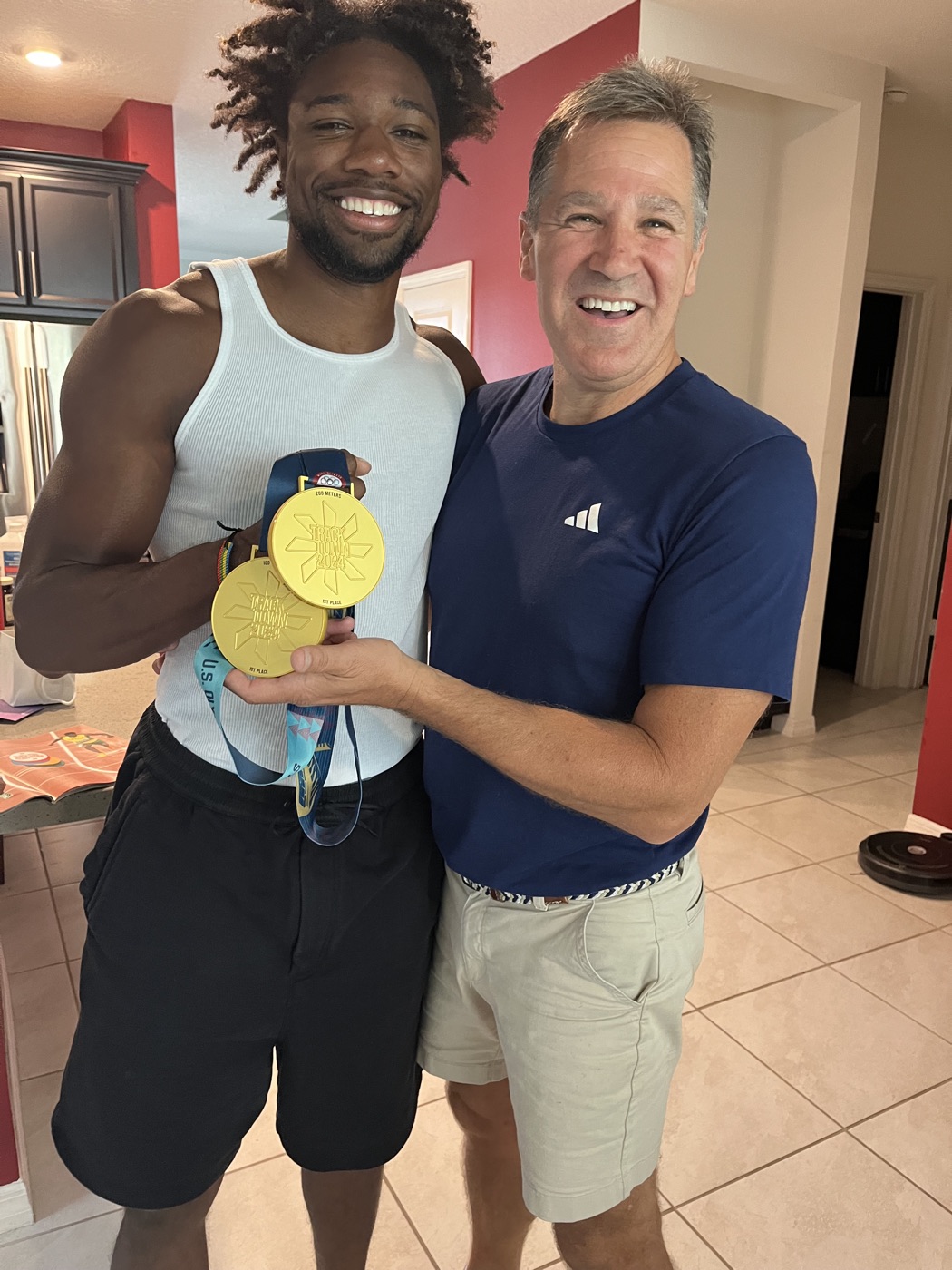 Dr. Obetz with Noah Lyles and his gold medals from the 2024 USA Olympic Trials