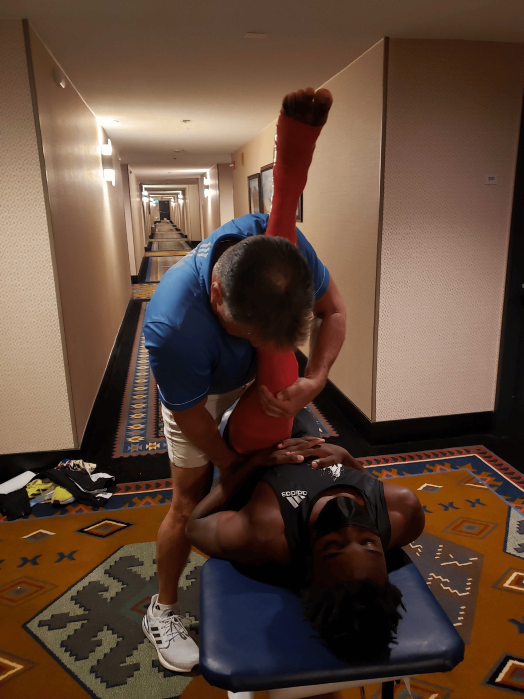 Dr. Obetz working on Noah Lyles before a race